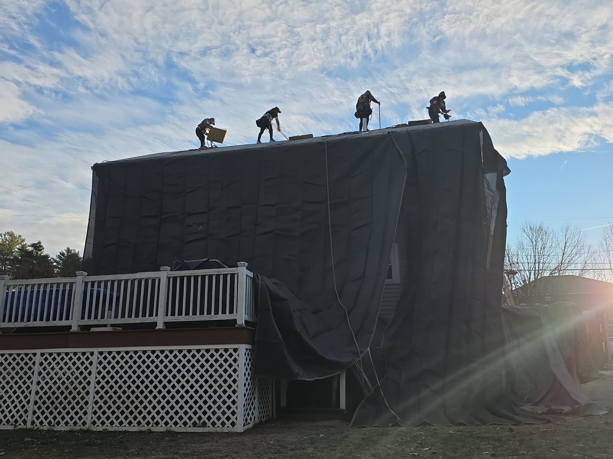 jasmor roofing crew on installation day - image of roof and home siding well protected